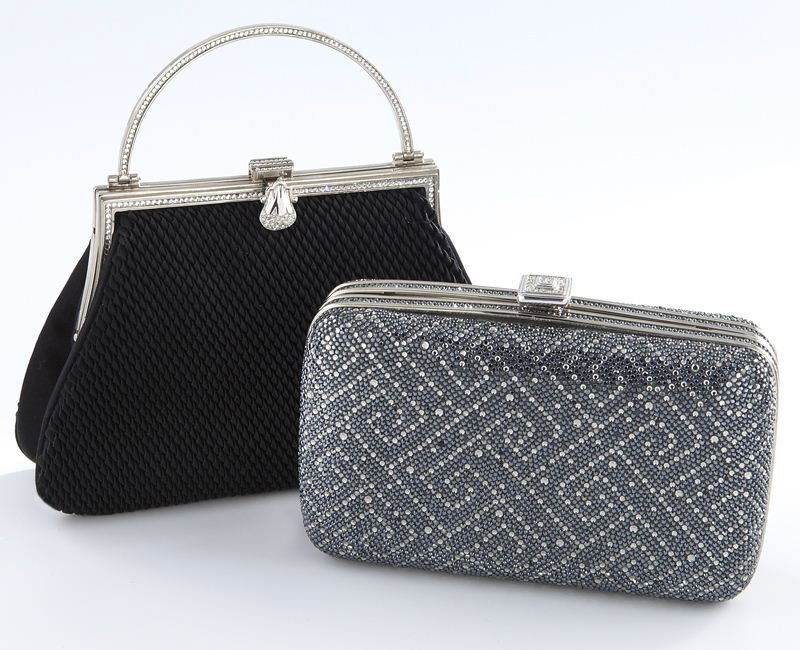 (2) Judith Leiber evening bags including:: (2) Judith Leiber evening bags including: (1) of box form, soft sides encrusted with silver tone Austrian crystals; and (1) of woven black peau de soie with silver tone frame and loop handle with chan