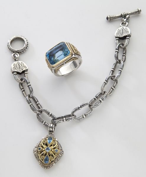 2 Pcs. Konstantino 18K, sterling, and topaz: 2 Pcs. Konstantino 18K, sterling, and topaz jewelry comprising a link bracelet, 8''L, and an associated ring, size 7. Stamped, "925 750." 48.7 grams. Circa - Contemporary.
