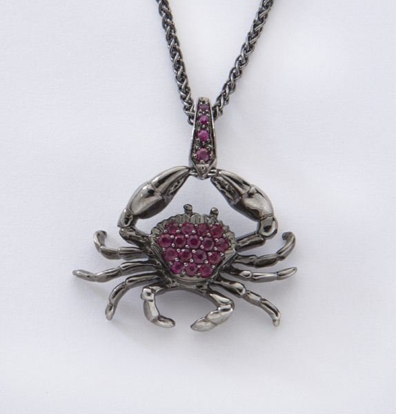 Stephen Webster 18K gold and ruby crab necklace,: Stephen Webster 18K gold and ruby crab necklace, the "jewels verne" crab pendant having 21 round rubies, .21 cts. approximate total, mounted in 18K white gold with rhodium plating on an 18K white gold