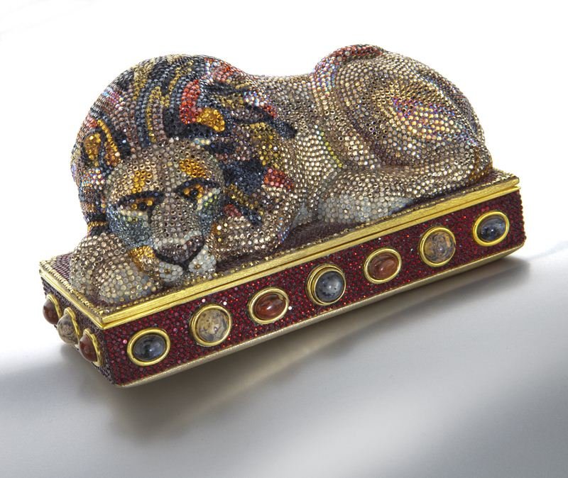 Judith Leiber crystal "Sleeping Lion" minaudiere: Judith Leiber crystal "Sleeping Lion" minaudiere with multi color cabochon hardstone inlay to the border, original coin purse, mirror, and comb enclosed inside. 3.5''H x 6''L x 3''W, Circa - Late 20th