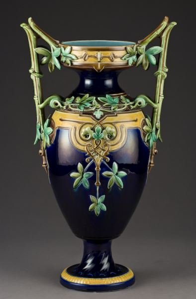 French Sarreguemines Majolica 2-handled vase: French Sarreguemines Majolica 2-handled vase in the Aesthetic Style modeled with a cobalt ground, the handles and neck covered with ivy vines. Base with impressed marks, "Majolica Sarreguemines S 505"