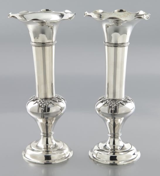 Pr. Wang Hing Hong Kong sterling vases: Pr. Wang Hing Hong Kong sterling vases of tulip form, each with a ruffled everted upper rim, chased leaf and berry motif to the bulbous waist. Marked "WH90" and stamped with a character. 10.035 ozt. 7