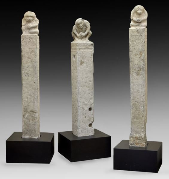 (3) Chinese Qing limestone figural hitching: (3) Chinese Qing limestone figural hitching posts, Shanxi province, depicting monkeys holding fruit tree branches, set in wood bases. Smallest: 90"H x 8.75"W x 8"D; Largest: 102"H x 10"W x 10.75"D, Ci