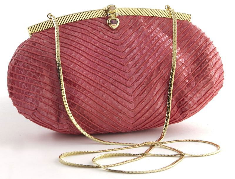 Judith Leiber coral lizard skin clutch: Judith Leiber coral lizard skin clutch with gold chain strap concealed within. 5.5 " H x 9" W,