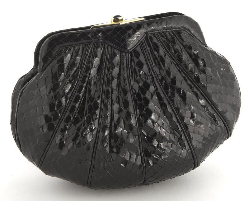 Judith Leiber black snake skin clutch: Judith Leiber black snake skin clutch with thin strap concealed within, labeled Judith Leiber to the interior. 5.25" H x 7" W, Circa - 1990's.