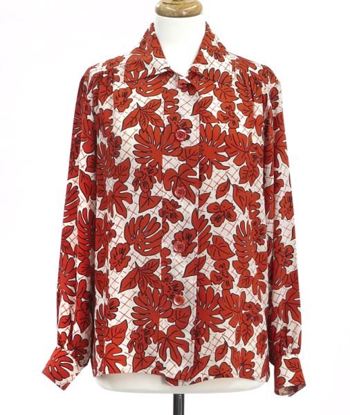 Yves St. Laurent red and white silk blouse: Yves St. Laurent red and white silk blouse featuring stylized leaves on a white ground, the blouse buttoning up the front. Tag marked Saint Laurent, Rive Gauche, size 40. Note: This piece is part of a