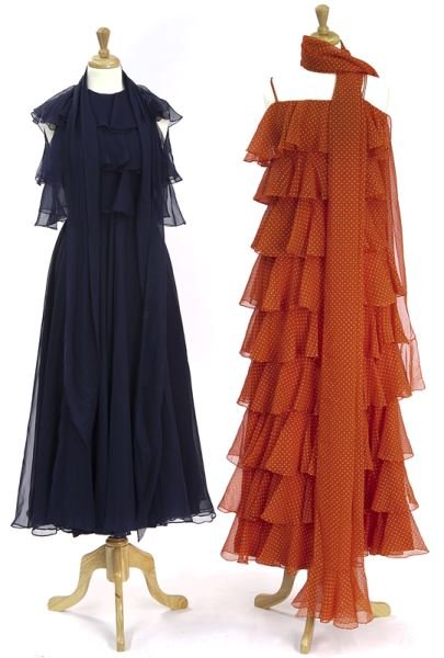 (2) Mollie Parnis evening dresses: (2) Mollie Parnis evening dresses (1) of ruffled navy blue chiffon measuring 51" L x 16" W at the bust, flat; (1) of red tiered chiffon with spaghetti straps and white polka dots measuring 56" L x 16"