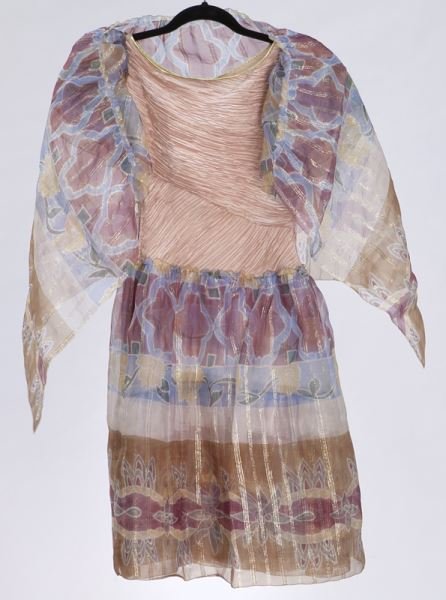 Mary McFadden silk and chiffon cocktail dress,: Mary McFadden silk and chiffon cocktail dress, the mauve pleated silk bodice with printed chiffon sleeves and full skirt in a stylized blue and mauve tribal pattern. Measuring 38" L x 16" W at the bus