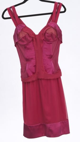 Stella McCartney red silk dress: Stella McCartney red silk dress styled as a deconstructed corset with heavy boning to the bodice, charmeuse mini-skirt and sheer straps. Measuring 38" L x 16" W at the bust, flat and 13" W at the wais