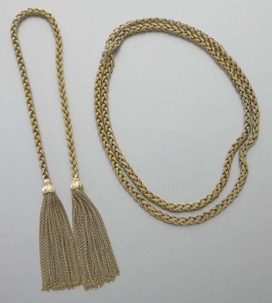 Pr. 18K gold braided necklace and matching: Pr. 18K gold braided necklace and matching bracelet, the bracelet ties and has tassels. The two pieces can be worn as one. Stamped, "18K NM Germany." 133.9 grams. Bracelet: 16"L; Necklace: 30"L, Circa