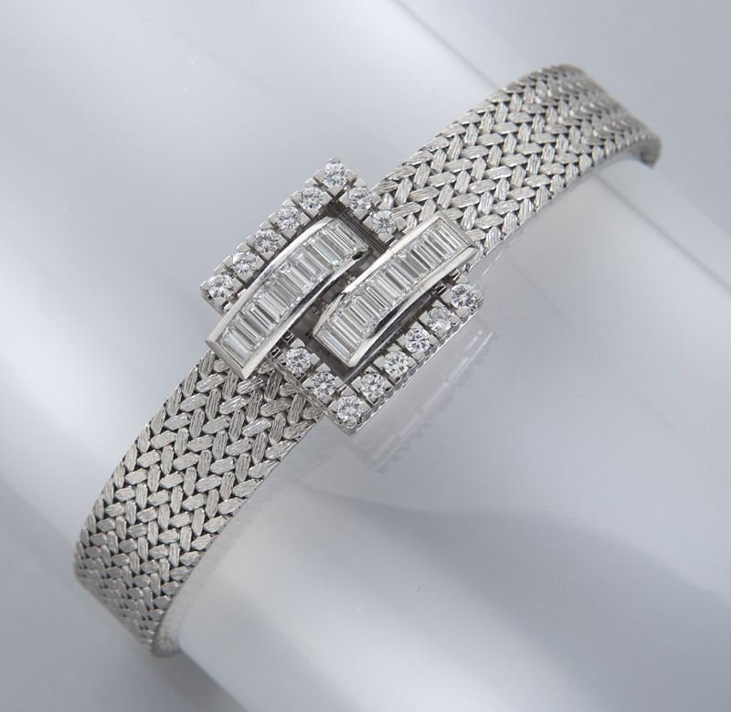 Piaget 18K gold and diamond bracelet watch: Piaget 18K gold and diamond bracelet watch featuring 16 round brilliant and 20 baguette cut diamonds, 3.0 cts. approximate total mounted in 18K white gold with an integral white gold mesh band. Back w