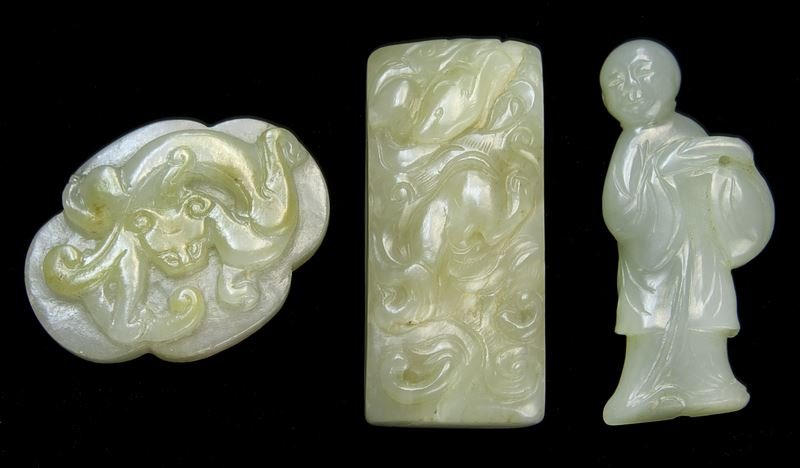 (3) Chinese Qing jade carvings.: (3) Chinese Qing jade carvings. (1) rectangular form sword slide carved with chilong in cloud motif in low relief; (1) one-sided plaque in the form of a standing boy; (1) similar plaque in quatrefoil