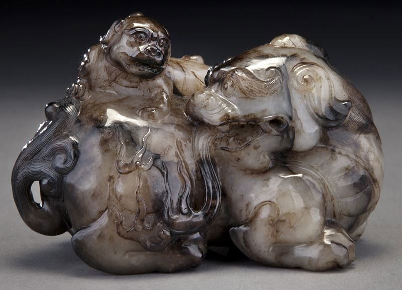 Chinese Ming style carved jade qilin group,: Chinese Ming style carved jade qilin group, carved from a large block of grey and black matrix, depicting a reclining qilin with her head turned back to look at her young, both featured in exquisite d