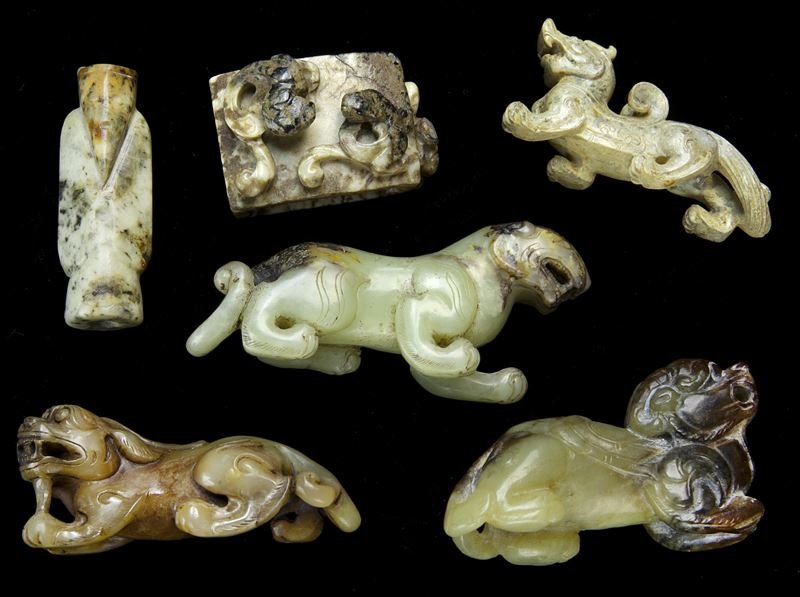 (6) Chinese Han style jade carvings.: (6) Chinese Han style jade carvings. (4) zoomorphic figures- tigers and mythical beasts, the stone matrix ranging from light celadon tone to grey, some with extensive calcification; (1) lucky charm in