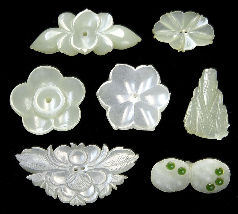 (7) Chinese Qing carved jade miniature costume: (7) Chinese Qing carved jade miniature costume ornaments, all perforated for thread attachment. Provenance: From the collection of a prominent Northern California collector. Largest: 2", Circa - Qing