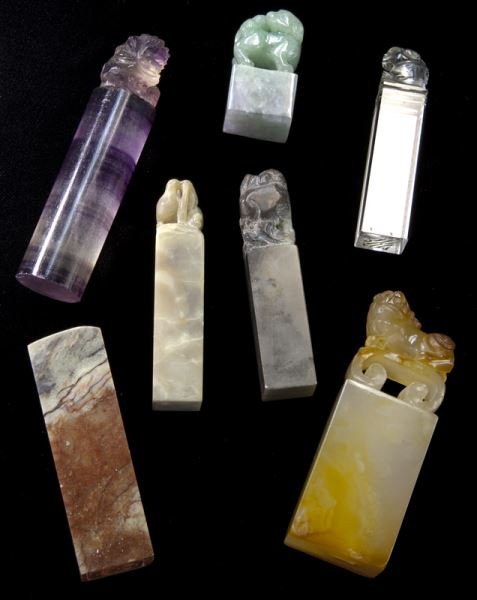 (7) Chinese Qing hardstone seals.: (7) Chinese Qing hardstone seals. (3) soapstone; (1) jadeite; (1) amethyst; (1) rock crystal; (1) agate, six of which are carved with a mythical beast on top. Provenance: From the collection of a prom