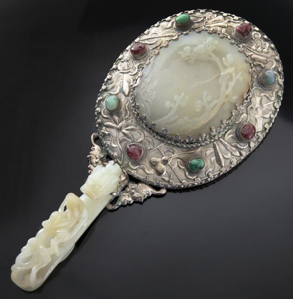 Chinese Qing jade mounted hand mirror,: Chinese Qing jade mounted hand mirror, the central jade pendant depicting a landscape, (3"H), surrounded by lucky symbols and tourmaline, with a carved jade belt buckle depicting a dragon as the handl