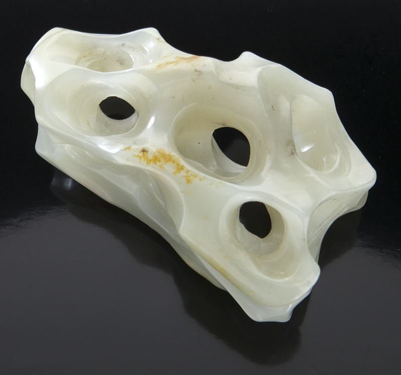 Chinese late Qing jade boulder (shanxi),: Chinese late Qing jade boulder (shanxi), the scholar's item nicely carved as a gnarled and hollowed taihu rock from a single piece of celadon tone nephrite with russet skin. 1.25"H x 3.25"W, Circa - L