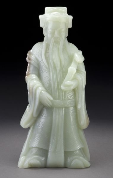 Chinese carved jade figure: Chinese carved jade figure depicting the God of Prosperity, holding a ruyi scepter in his left hand. 9.25"H, Circa - 20th C.