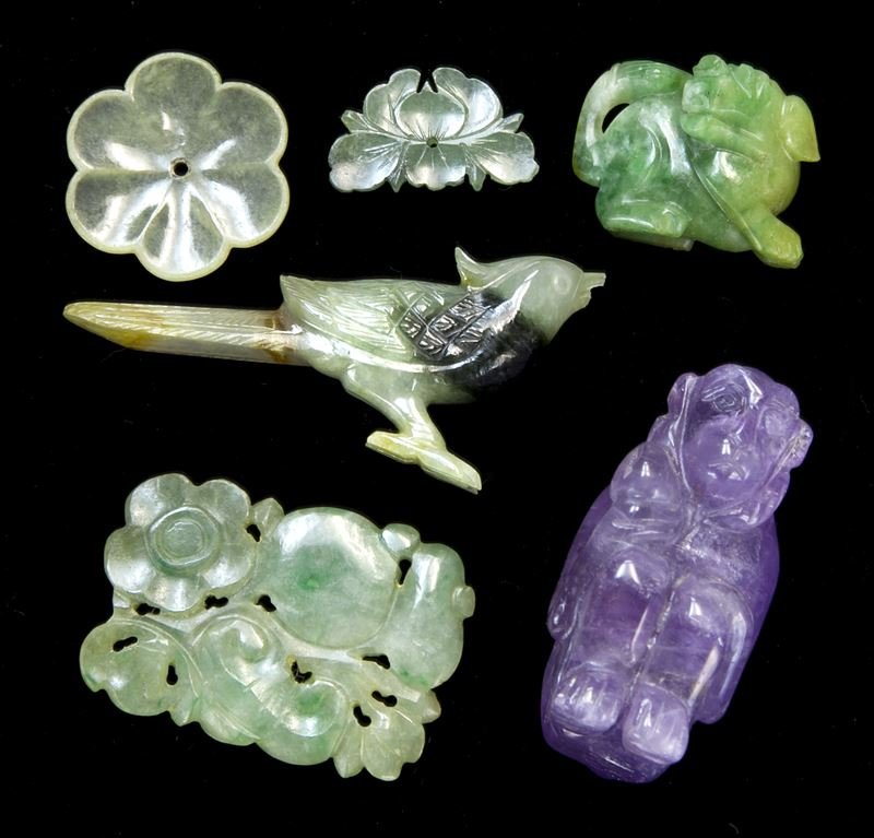 (5) Chinese carved jadeite miniatures: (5) Chinese carved jadeite miniatures and (1) amethyst monkey toggle. The (5) jadeite include costume ornaments in floriform and (2) zoomorphic figures, all with good translucence and some apple green