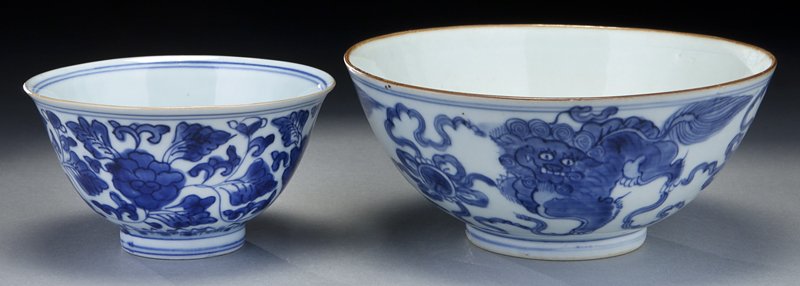 (2) Chinese Ming blue and white porcelain bowls.: (2) Chinese Ming blue and white porcelain bowls. (1) large bowl with curvy exterior wall rising to a straight rim, depicting a group of lions playing with ribboned brocade balls, the base bears a four