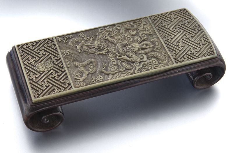 Chinese Republic rectangular ink rest: Chinese Republic rectangular ink rest with carved soapstone panel, depicting a writhing dragon amidst clouds and waves, mounted on a hardwood base. 1.5"H x 6.75"W x 2.75"D, Circa - 1911-1949.
