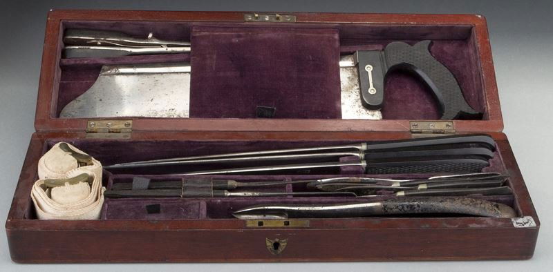 Cased set of field surgeon's instruments: Cased set of field surgeon's instruments including scalpels, knives, saw, and tourniquets, pieces manufactured by W.B. Hilliard, Charriere, Gardner Edinburch and Coxeter, in a fitted mahogany case. 5"