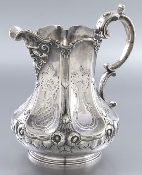 John C. Moore coin silver water pitcher: John C. Moore coin silver water pitcher of hexagonal form with chased floral decoration to the body, mask form spout, produced for Mulford & Wendell, retailers. Marked for John C. Moore and Mulford &