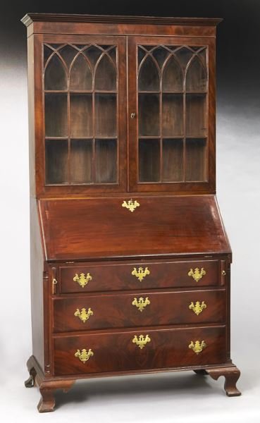 American Federal secretary bookcase: American Federal secretary bookcase in mahogany with nicely fitted bureau desk over three graduated drawers flanked by reeded quarter columns, on shaped "ogee" bracket feet. Provenance: from the heirs