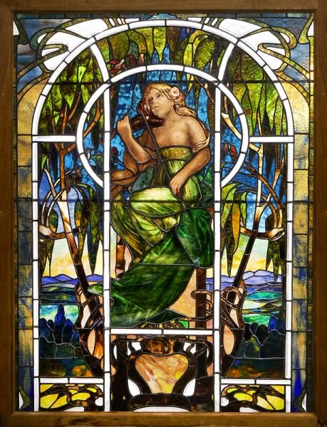 Large Art Nouveau stained glass window: Large Art Nouveau stained glass window depicting a woman. Measuring 73" H x 55.5" W including the the frame; 65.75" H x 49" W without the frame.