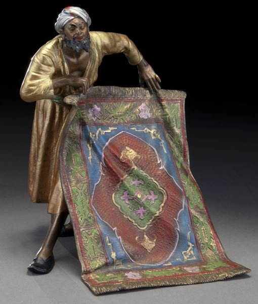 Franz Xavier Bergman "Carpet Seller", cold painted: Franz Xavier Bergman "Carpet Seller", cold painted bronze figure. Marked with a "B" in an amphora and "Austria" and "KF" in a diamond. Franz Xavier Bergman (Austrian 1861-1936). 8.5"H x 7"W x 6"D Circ