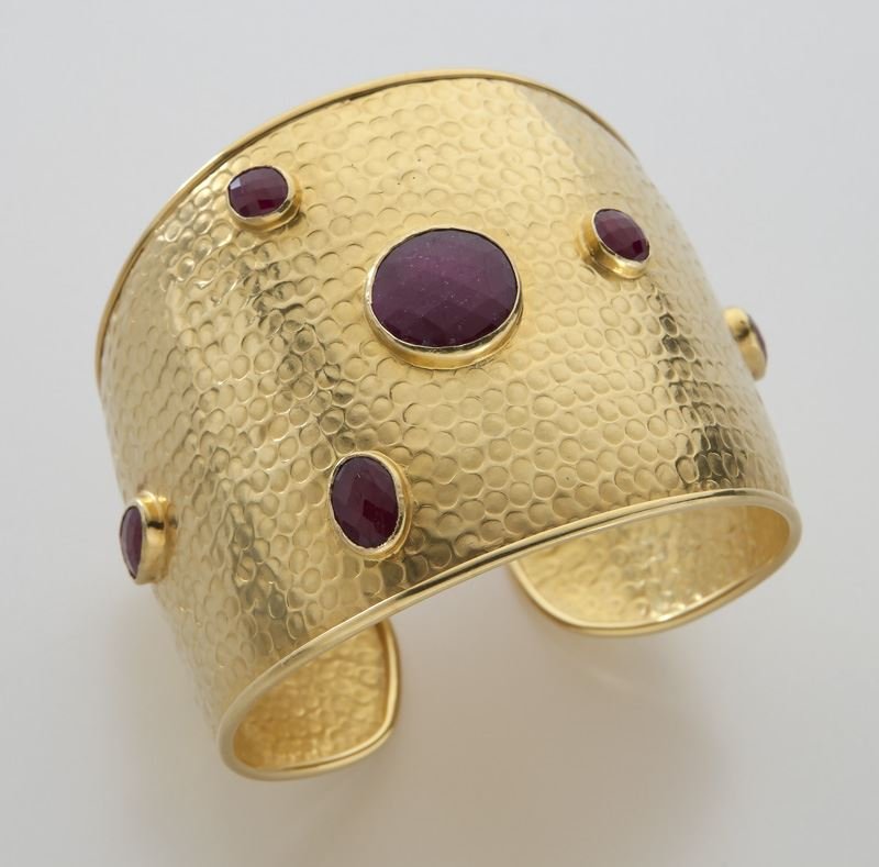 18K yellow gold and ruby cuff bracelet.: 18K yellow gold and ruby cuff bracelet. Stamped, "18K." 45 grams. 2" W, Circa - 20th C.