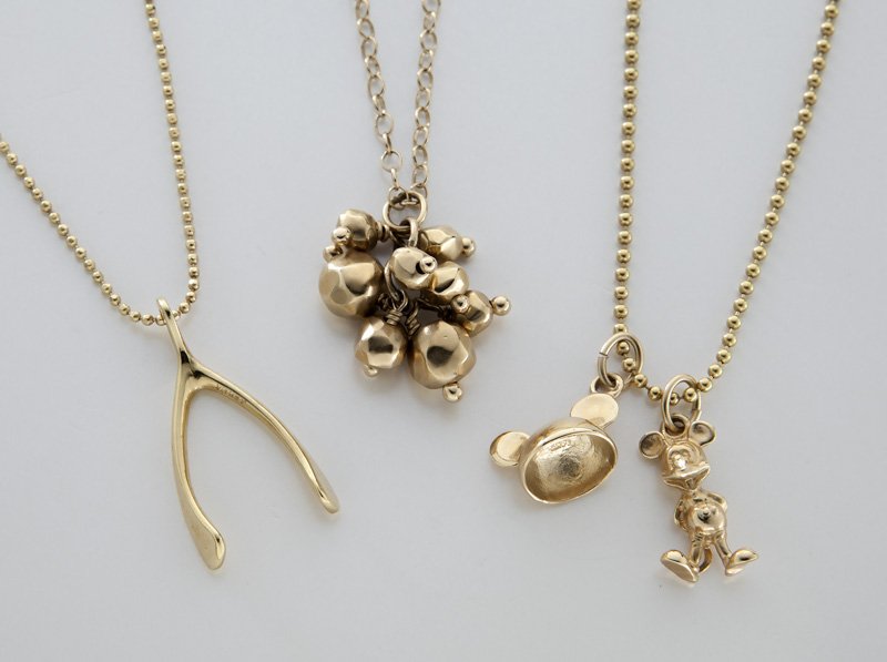 (3) 14K gold delicate pendants on chains: (3) 14K gold delicate pendants on chains including (1) Micky and Minnie Mouse, (1) wishbone, both stamped, "(star) 1 AR 14K" and Micky and Minnie "Uncaerre" and (1) cluster necklace stamped, "DP 585."