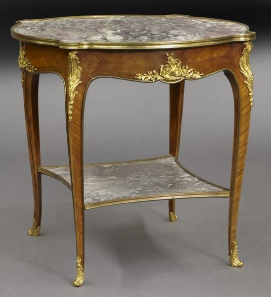 Louis XV style gueridon with bronze mounts and: Louis XV style gueridon with bronze mounts and marble top, shaped top over conforming base raised on cabriole legs joined by marble shelf. 30"H x 33"Dia, Circa - 1900.