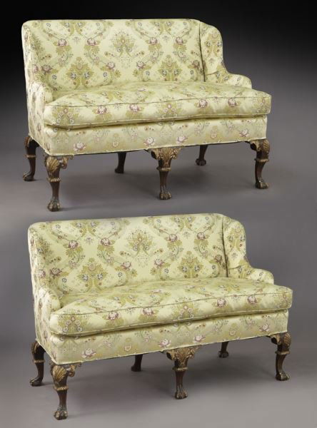 Pr. George III style parcel gilt settees: Pr. George III style parcel gilt settees standing on six shell carved cabriole legs, five with ball and claw carved feet. Upholstered in a floral decorated silk fabric. 40.75"H x 55"W x 31"D, Circa -