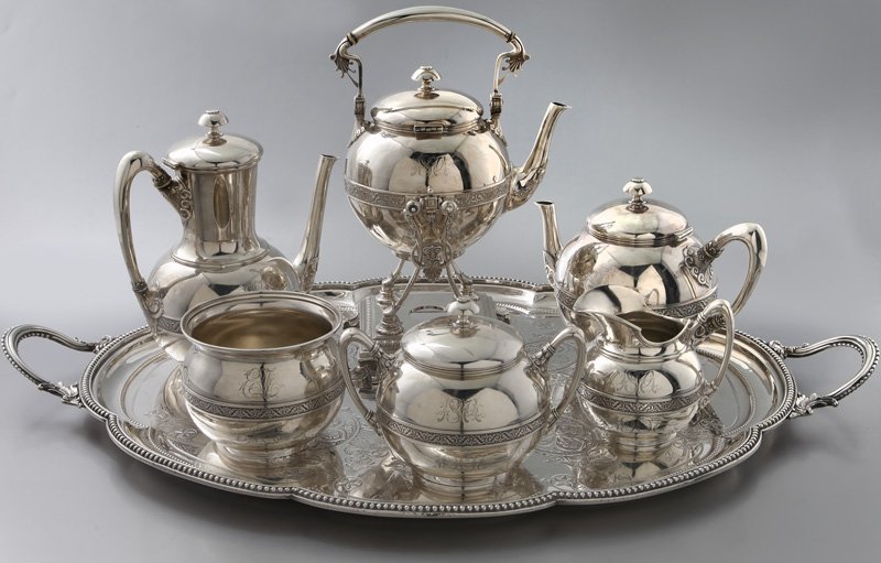 7 Pc. Starr & Marcus silver tea and coffee service: 7 Pc. Starr & Marcus silver tea and coffee service comprising: a tilting hot water kettle on stand, 10.5"H; a coffee pot, 9.5"H; tea pot, 6.5"H; sugar bowl with lid, 5.75"H; a creamer; and a waste bow