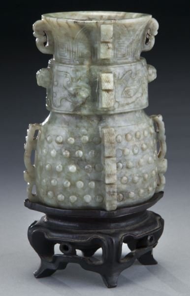 A Chinese Ming jade vase Jun: A Chinese Ming jade vase Jun with taotie masks and embossed grain pattern, flanked by two stylized dragons as handles, accented with two Buddhist lion masks in relief on the shoulder, the body feature