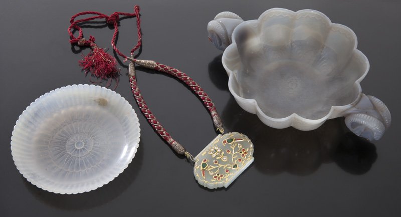 (3) Mughal style carvings including:: (3) Mughal style carvings including: (1) Pendant depicting birds and flowers with rough cut semi precious gemstones, 1.5"H x 2.5"W; (1) foliated dish, 4.75" Dia.; (1) brush washer with rams head handl