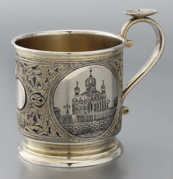 Maria Semenova Russian sterling niello tea glass: Maria Semenova Russian sterling niello tea glass holder, the gilt body decorated with niello floral and foliate scrolls featuring a view of a cathedral on one side, the other side with a view of the K