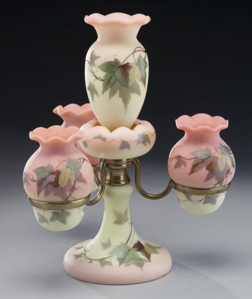Thomas Webb & Sons decorated Burmese epergne,: Thomas Webb & Sons decorated Burmese epergne, a rare and fine Webb Queen's Burmese three-arm epergne surmounted by a central urn-form vase in peach and butter yellow, with applied vine decoration, tog