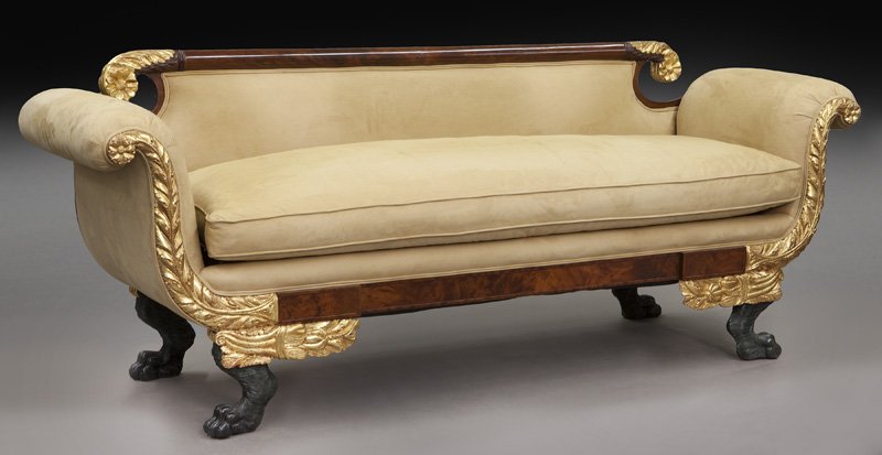 Federal parcel gilt carved mahogany sofa,: Federal parcel gilt carved mahogany sofa, having crest rail with gilt acanthus ends over scrolled arms having similar decoration raised on ebonized carved paw feet. 32.5"H x 84.5"W x 24.5"D, Circa - E