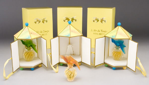 (3) Lalique Nina Ricci colored dove perfume: bottles with original cases and decorative boxes, (1) blue dove; (1) green dove; (1) yellow dove. 4"H, Circa - Mid 20th C.