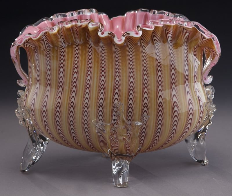Stevens and Williams Northwood pull-up bowl,: Stevens and Williams Northwood pull-up bowl, ovoid free form having scalloped rim decorated with alternating cranberry and amber pull ups, cased pink interior, adorned with crystal lip wrap and four r