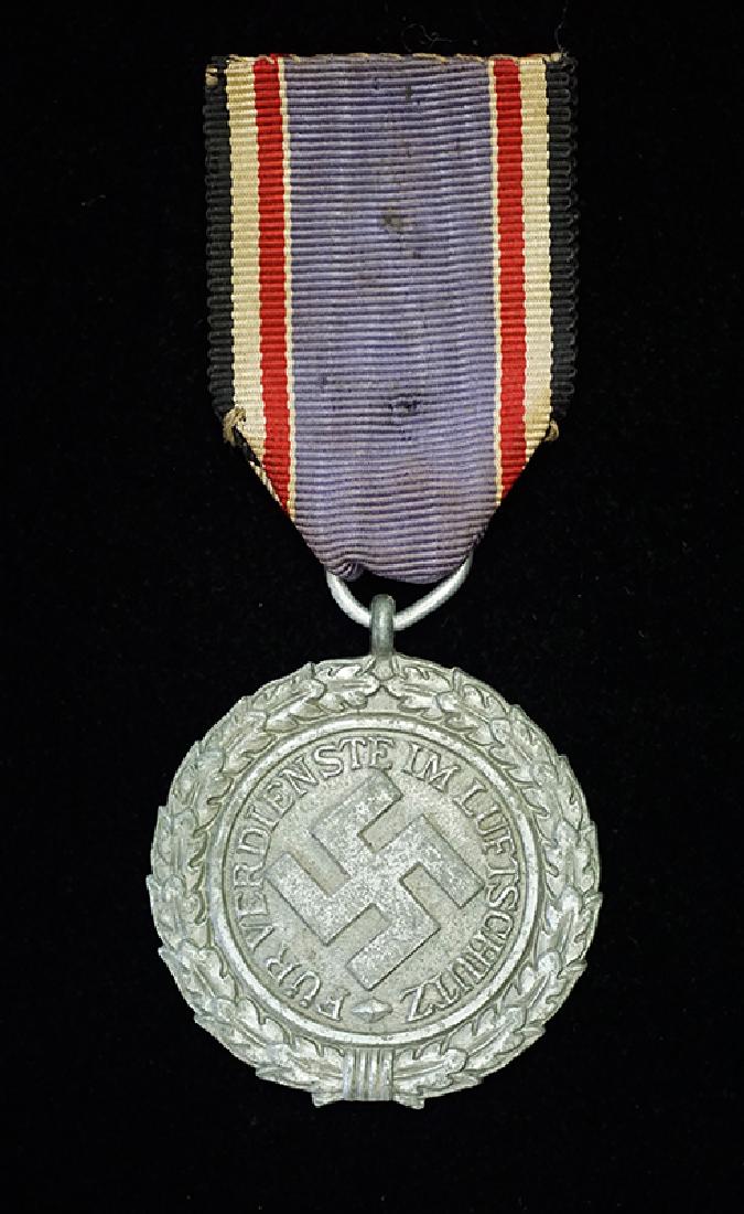 WWII German Luftschutz Service Medal: German 3rd Reich Luftschutz Service Medal 2nd Class; original ribbon with claps; wartime zink -excellent condition.