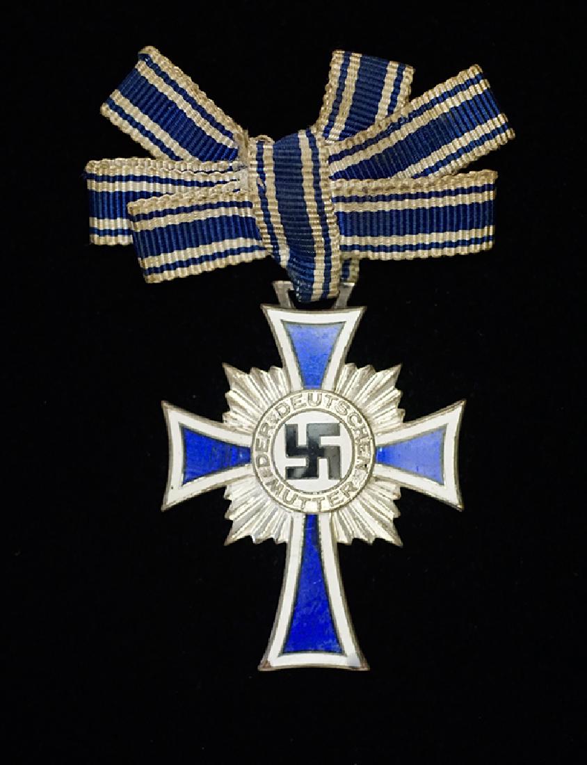 WWII German Mothers Cross in Silver: German 1938 'Honor Cross of the German Mother' in Silver;97% finish bown configured ribbon with clasp for wear -excellent condition.