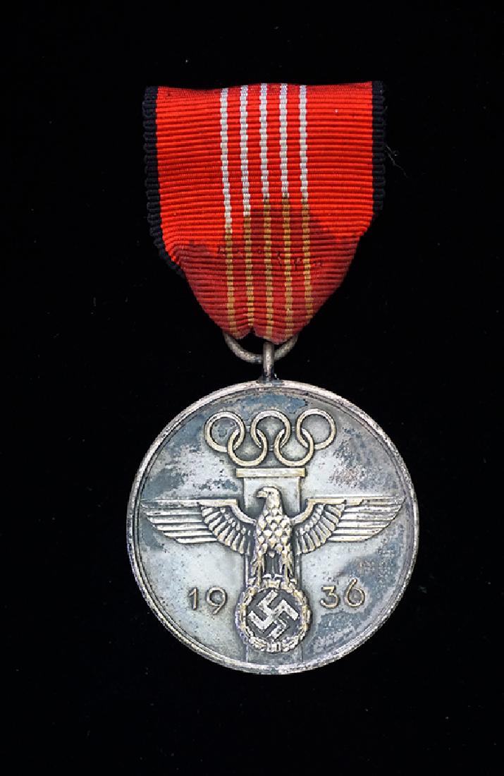 German 1936 Olympic Games Medal: German 1936 Olympic Games Commemorative Medal; silver plated on original ribbon with clasp -excellent conidition.