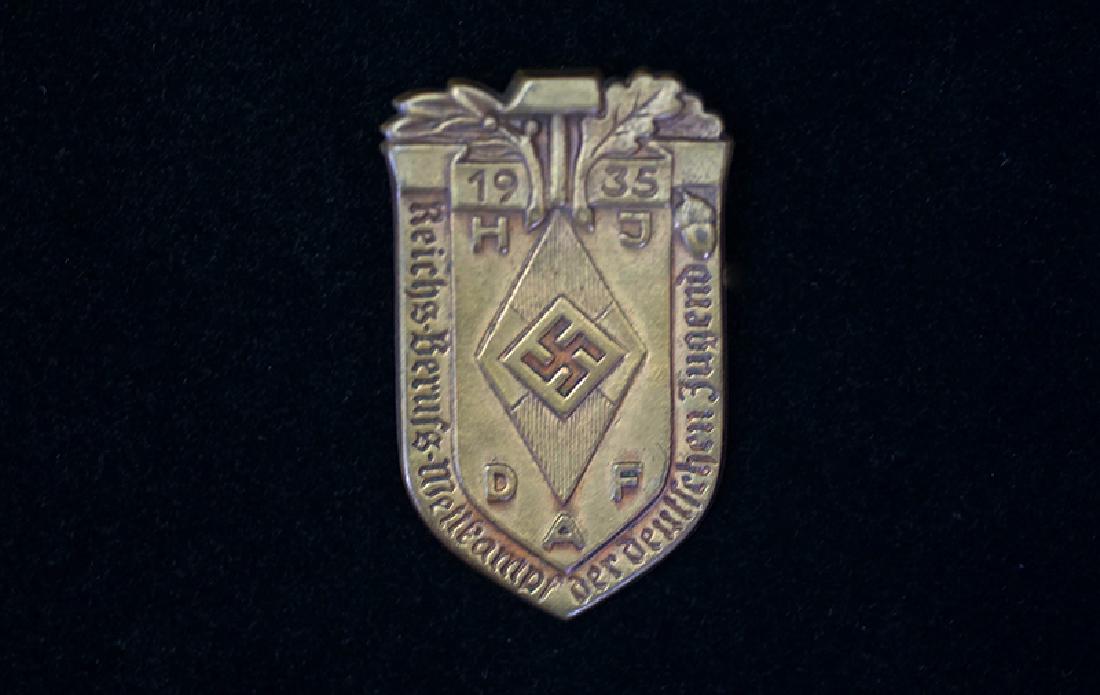 German 1935 HJ-DAF Wettkampf Badge: German 3rd Reich HJ tinniel dated 1935; 45mm bronze alloy with pinback; maker marked reverse; near mint condition.