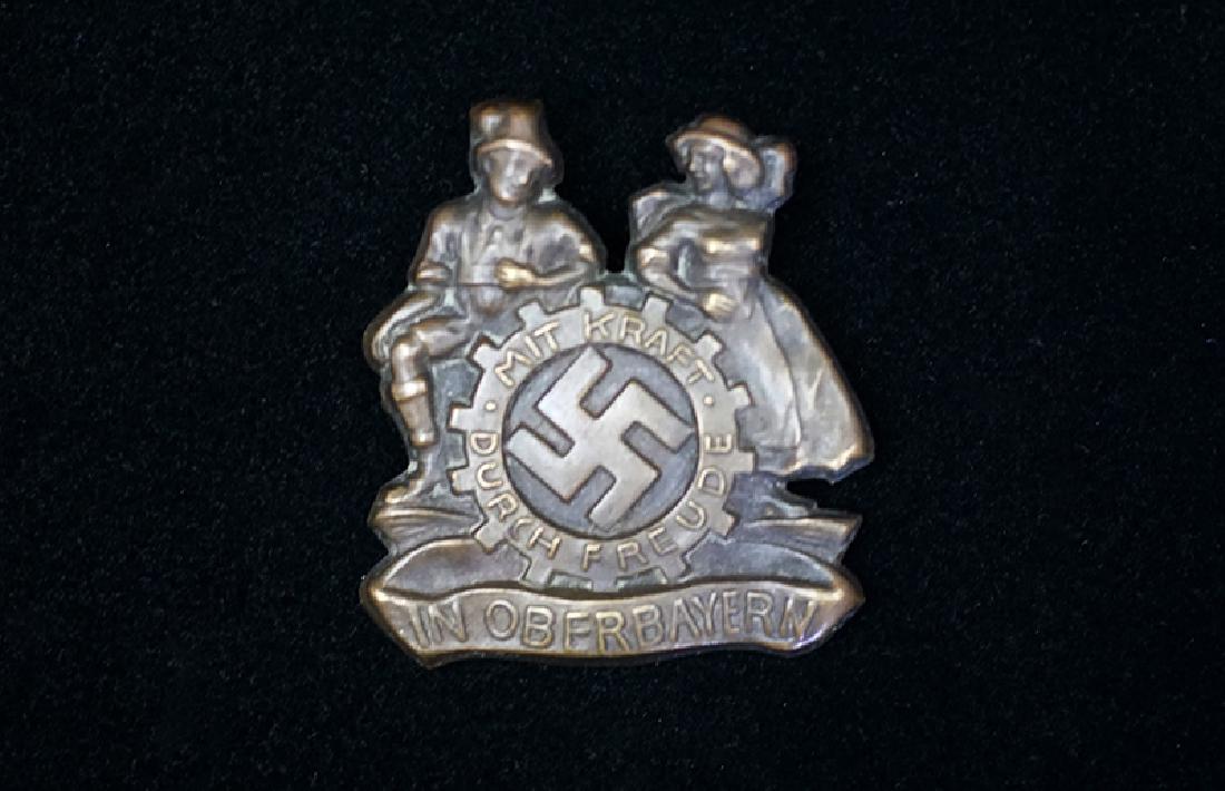 German KDF Oberbayern Badge: German 3rd Reich tinnie; undated Labor Corps related; 45mm bronzed steel-alloy with pinback; mint conidition.