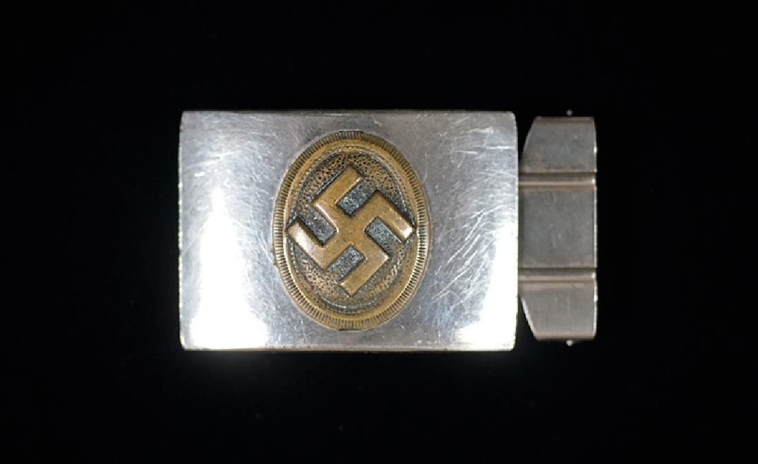 German HJ/DJ Belt Buckle: German 3rd Reich Belt Buckle of the Deutsche Jungvolk; nickle steel small narrow guage trouser buckle having obverse gilt swastika motif for the youngest DJ members.