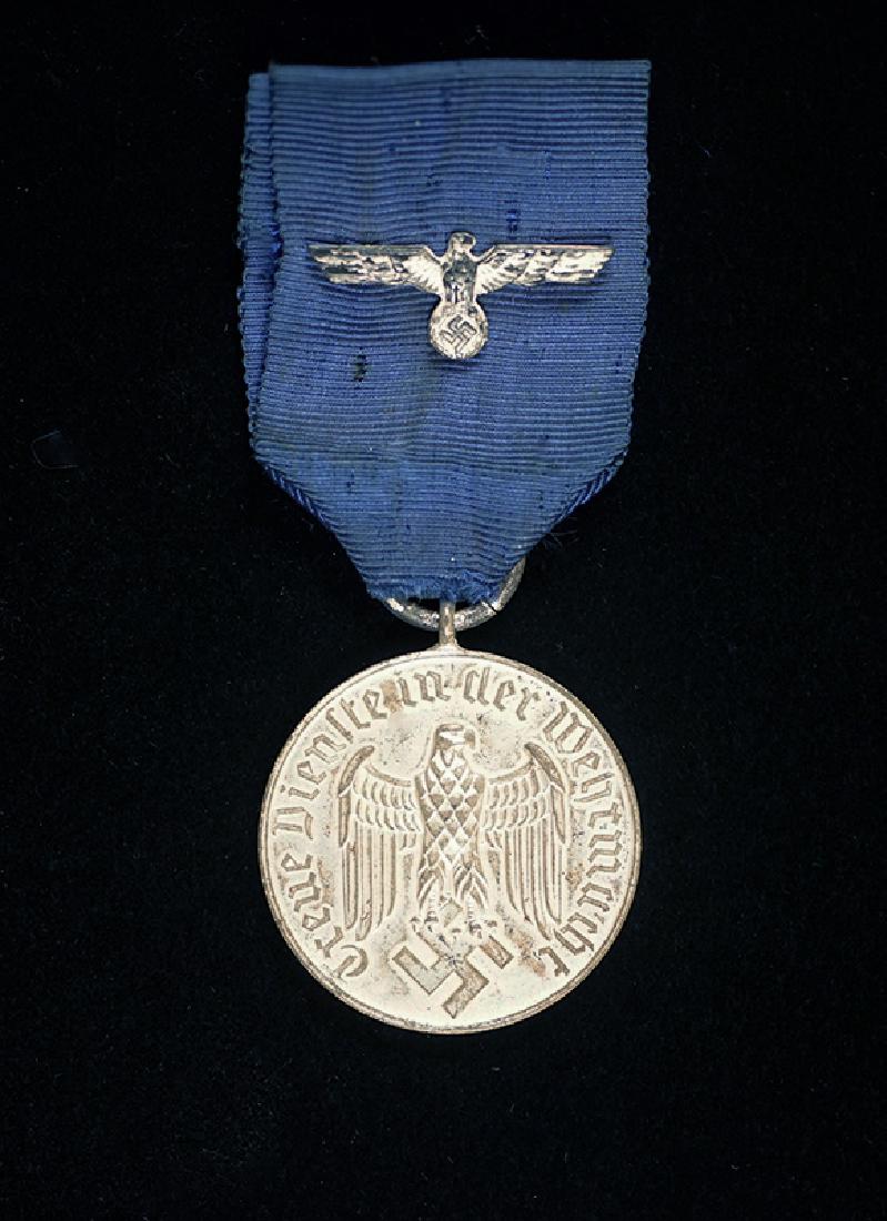 WWII Wehrmacht 4 Year Service Medal: Wehrmacht 4 Year Army or KM Long Service Medal; silvered medal on its original ribbon having Wehrmacht Eagle device; excellent condition.